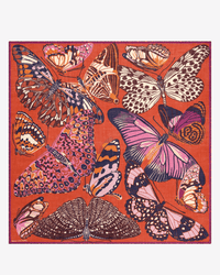 The Inoui Editions Square / Carre 130 Papillons in Red is a silk scarf adorned with colorful butterfly illustrations in orange, pink, purple, and cream on a vibrant red background.