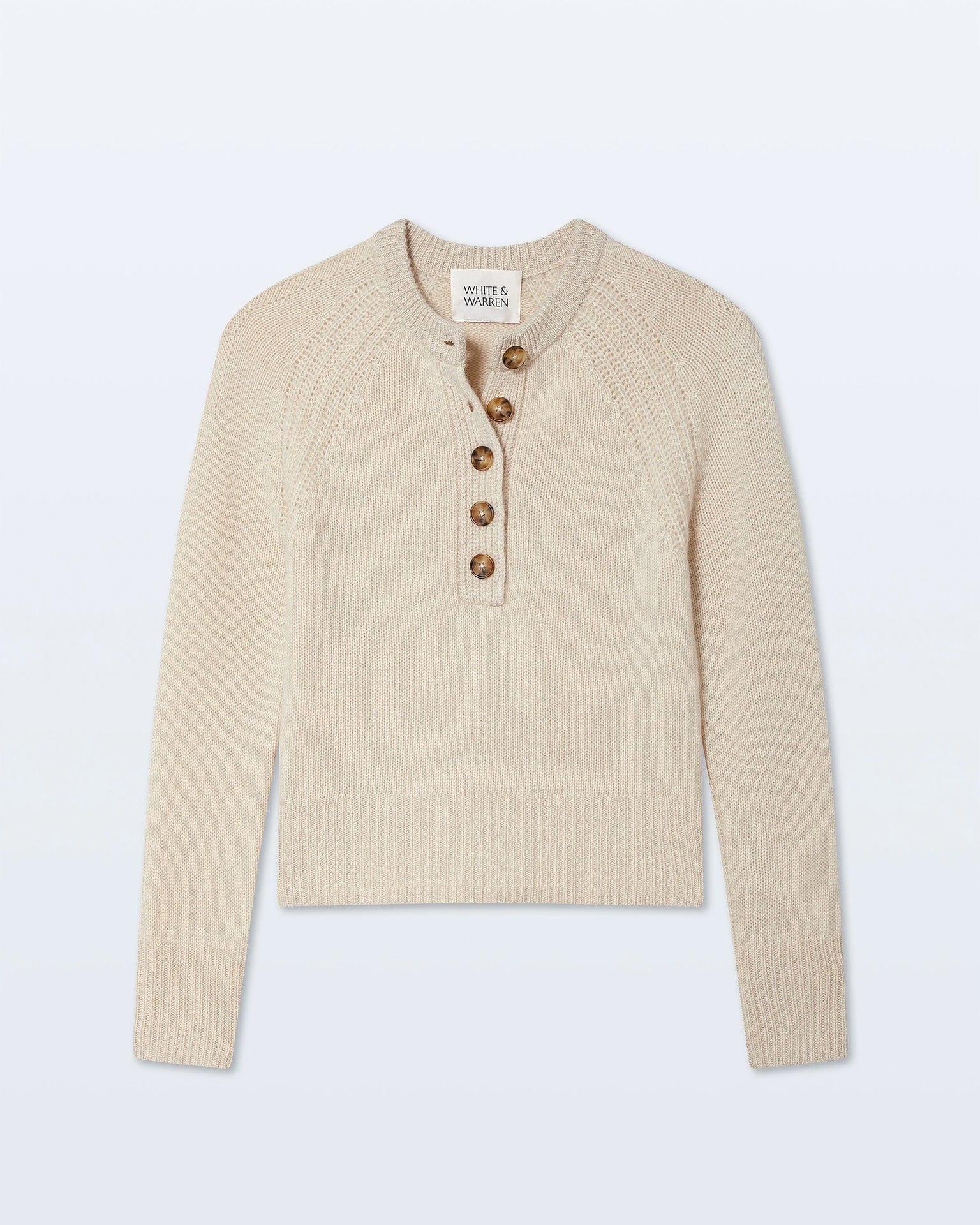 The White & Warren Cashmere Luxe Henley in Natural Heather is a lightweight cashmere sweater featuring long sleeves, ribbed cuffs and hem, a classic four-button henley neckline, and textured shoulder detailing.