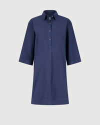 The Hartford Rank Henley Dress in Midnight is a knee-length cotton poplin dress with a collar, three-quarter sleeves, buttoned placket, and side pockets—ideal for a casual chic look, shown on a plain light background.