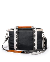 The Premium Cooler Bag - Rivie Black by Business & Pleasure Co is a rectangular black fabric bag with a zippered top, leather accents, and a detachable shoulder strap with a wavy black and white pattern for vintage appeal.