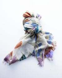 The Épice Bold Daisy Wool Silk & Cashmere Scarf in Taupe, featuring a hand-printed abstract daisy pattern, is shown loosely knotted on a white background.