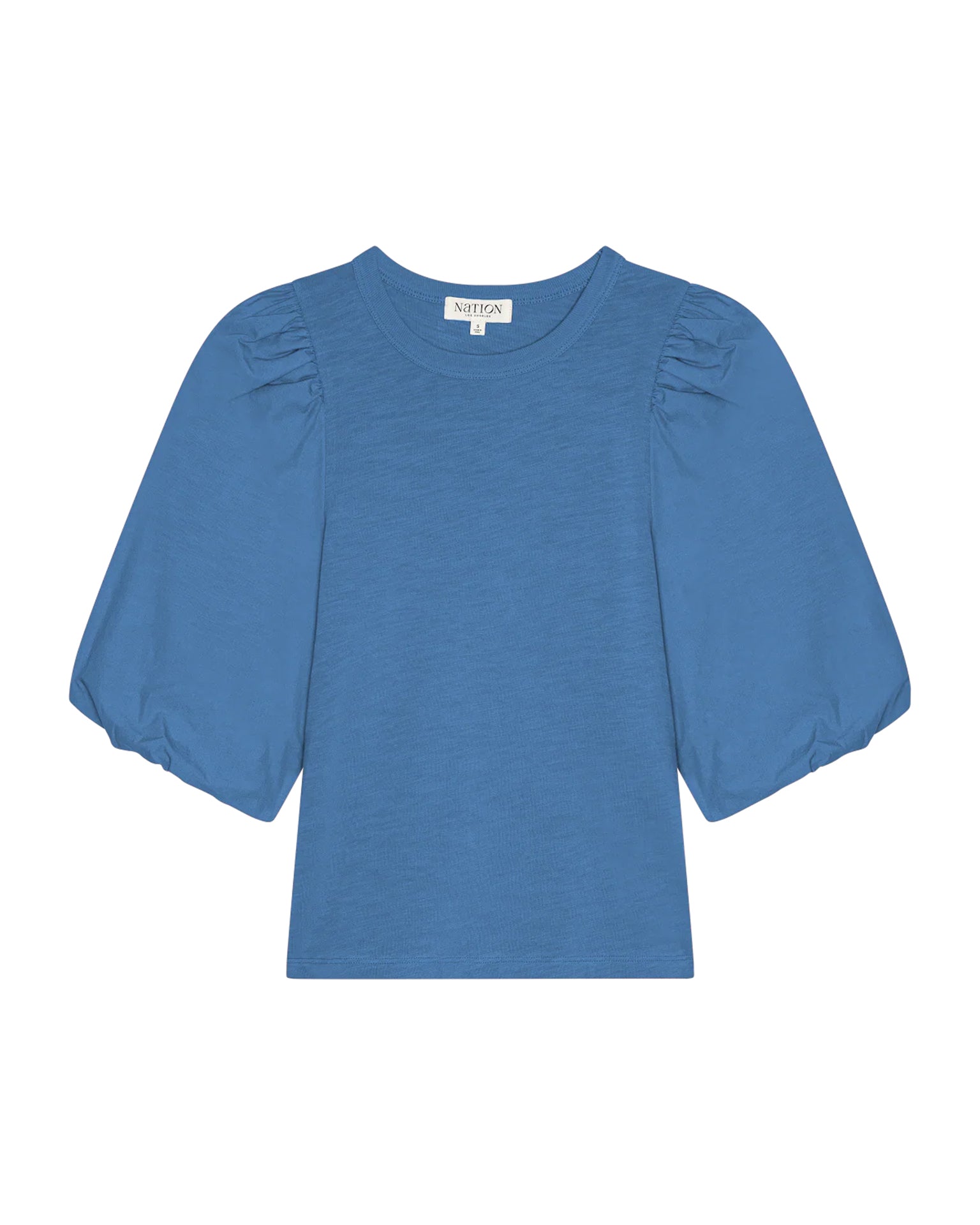 The Nation LTD Tippi Top in Harbor Blue is crafted from soft slub cotton, featuring puff sleeves, a crew neckline, and a slightly loose fit, shown against a white background.