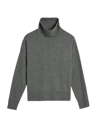 The Demylee Gianna Cashmere Turtleneck in Dark Heather Grey features long sleeves and ribbed cuffs, hem, and neck. Laid flat on a white background, it highlights its relaxed fit.