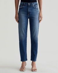 A person models the AG Jeans Rian High-Rise Straight in Lake Como, styled with open-toe heeled sandals, against a plain light background.