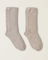 The Barefoot Dreams CC 2 Pair Sock Set in Stone Multi features two pairs of soft, fuzzy socks—one light gray and one beige—laid side by side, perfect for adding cozy comfort to any day.