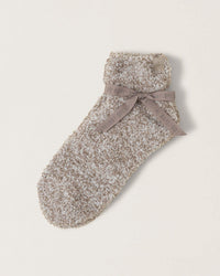 A single Barefoot Dreams CC Heathered Tennis Sock in Nickel/White with a folded cuff, tied with a gray Barefoot Dreams ribbon, displayed on a plain background. Ideal for those seeking plush tennis sock comfort.