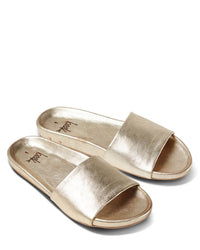 A pair of beek.. Gallito in Platinum slides with wide straps, open toes, and a memory foam sole, shown on a white background.