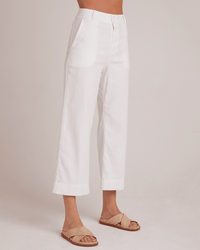 A person wears the Bella Dahl Saige Wide Leg Crop in White and tan open-toe sandals, standing against a plain light background. The photo is cropped at the waist and ankles.