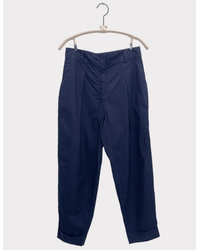 The Inez - Parachute in Navy by A Shirt Thing: dark blue, high waist, straight leg trousers with front pleats and cuffed hems, displayed on a light wood hanger against a plain white background.