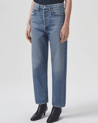 Wearing AGOLDE 90s Crop Mid Rise Loose Straight in Hooked, paired with black ankle boots and a dark top, standing against a plain white background.