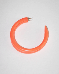 The B&L C Hoop in Large from Charlotte's Hoop is a bold, thick orange hoop earring with a pointed end and exposed metal post, handcrafted from sustainably sourced mango wood and shown on a plain white background.