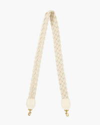 The Clare V. Braided Rope Crossbody Strap in Cream with leather tabs features a braided design and gold swivel hooks at both ends, shown against a white background.