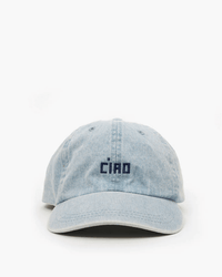 The Clare V. Emb Petit Block Ciao Baseball Hat in Light Denim w/ Navy features "Ciao" embroidered in dark blue on the front and is shown against a plain white background.