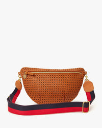 The Grande Fanny in Tan Rattan by Clare V. features a brown woven design, gold zipper, and wide navy blue and red striped adjustable strap. Displayed on a white background, this chic crossbody is perfect for everyday use.