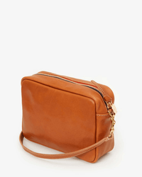The Clare V. Midi Sac in Tan Napetto is a rectangular Italian leather bag with a zippered top and adjustable strap, displayed on a white background.