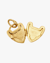 The Clare V. Padlock Locket in Vintage Gold is pictured open, displaying empty spaces on both sides for small photos or keepsakes—a classic necklace charm.
