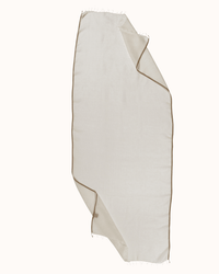 The Épice Solid Scarf in Rose White, featuring a soft cream hue with subtle brown edging, is loosely folded and draped against a plain light background.
