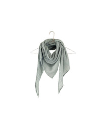 The Gauze Triangle Scarf in Sage by It is well LA, crafted from 100% cotton with a textured crinkle finish, hangs on a metal hanger against a plain white background.