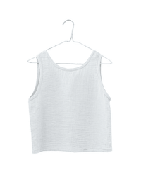 The Sleeveless Crop Top in Salt by It is well LA, made from textured organic cotton, hangs on a white hanger against a plain white background.