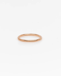 The Nashelle Pure Ring in Gold, crafted in 14k gold fill, is a simple and dainty piece displayed on a plain white background—ideal as a stacking ring or worn solo for timeless elegance.