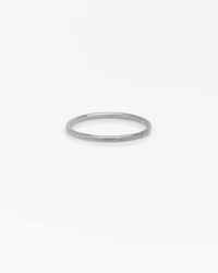 The Nashelle Signature Ring in Silver, featuring a smooth, slightly faceted surface, is showcased against a plain white background.