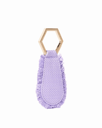 The Fray in Lilac by TopTote is a unique handbag accessory featuring a light wooden hexagonal ring and a textured, fringed lavender fabric pendant, beautifully displayed on a white background.