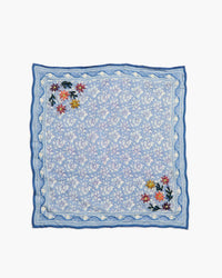 Blue floral embroidered square on a white background