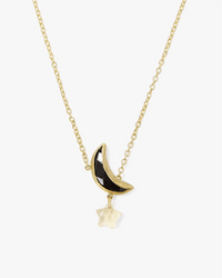 The Chan Luu Moon & Star Necklace in Black Mix features a black crescent moon pendant with a white star charm on an 18k gold plated sterling silver chain, shown against a plain white background for an elegant look.