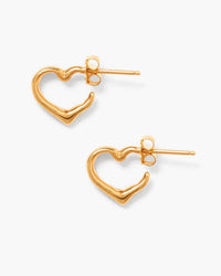 The Chan Luu Open Heart Post Gold Earrings are handmade gold studs shaped like abstract open hearts, featuring posts and butterfly backings, showcased on a simple white background.