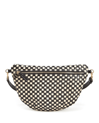 The Clare V. Grande Fanny in Black & Cream Woven Checker features a checkered design, front zipper pocket, black strap, and gold hardware, shown against a white background.