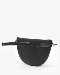 The Clare V. Grande Fanny in Black Perf is a black, semi-circular fanny pack featuring a textured, perforated Italian leather surface and an adjustable black strap with gold-tone hardware, shown on a white background.