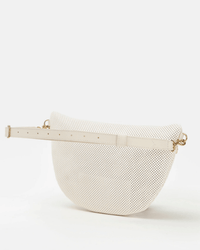 The Clare V. Grande Fanny in Cream Perf is a white, perforated leather belt bag with gold hardware, a structured, rounded design, and an adjustable strap for hands-free versatility, shown against a plain white background.