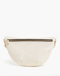 The Grande Fanny in Cream Perf by Clare V. is a cream-colored, half-moon crossbody bag made from vegetable-tanned Italian leather with black polka dots, a gold top zipper, and elegant gold hardware on the sides.