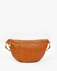 The Clare V. Grande Fanny in Natural Woven Checker showcases a modern twist on the classic fanny pack with its chic woven design and adjustable strap, elegantly displayed against a plain white background.