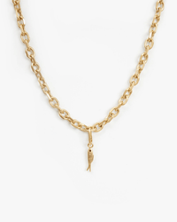 The Clare V. Sardine Charm in Vintage Gold is a gold chain necklace with oval links, featuring a fish-shaped pendant at the center, shown against a plain white background.