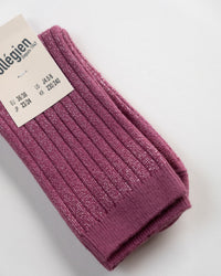 A pair of Collegien Victoire Extra Soft Glittery Socks in Raisin Rose, with a white size info tag for EU, JP, US, and KR, are displayed on a white surface.