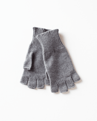 A pair of COLORI Fingerless Gloves in Kensington, featuring a gray cashmere design and ribbed cuffs, is neatly stacked on a white background.