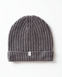 The COLORI Ribbed Beanie in Beaver features a folded brim and a small white tag on the front, shown laid flat against a white background.