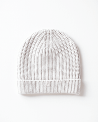 The COLORI Ribbed Beanie in Stucco features a light grey ribbed design with a folded cuff, shown flat on a white background—ideal for keeping cozy in winter.