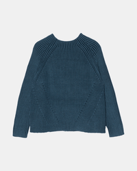 The Demylee Daphne Sweater in Indigo, a blue long-sleeved mockneck with ribbed knit texture, is laid flat on a plain white background showing its front side.