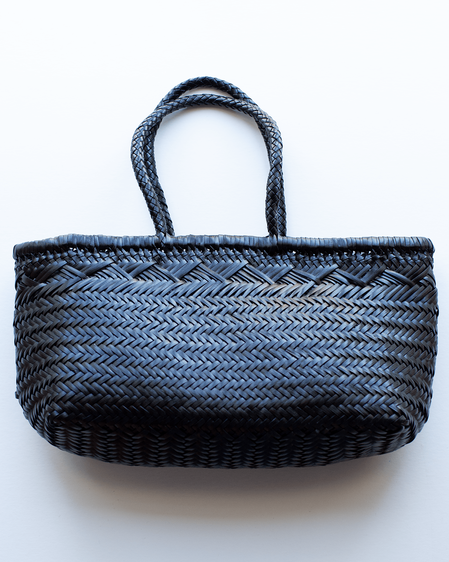 The Bamboo Triple Jump - Large - 6 Lines in Black by Dragon Diffusion is a black handwoven leather handbag with two handles, displayed on a white background.