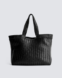 The Oversize Bag in Black by Dragon Diffusion, featuring two handles and a woven design, is displayed against a light gray background.