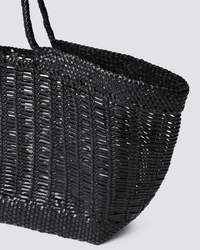 Close-up of the Window Shopper in Black by Dragon Diffusion, a hand-crafted tote with two handles and a basket-like textured pattern, photographed at an angle against a light gray background.