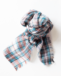 The Épice Small Square Check Scarf in Turquoise is a soft, hand-woven wool scarf with slightly frayed edges for a relaxed look, shown loosely knotted on a white background.