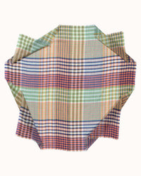 The Épice Varied Plaid Bandana in Confetti is a handwoven fabric swatch with rough edges, showcasing intersecting lines in green, blue, orange, red, and beige on a white background.
