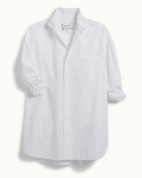 The Shirley Oversized Button Up in White Everyday Poplin by Frank & Eileen features long sleeves, a front chest pocket, slightly wrinkled sleeves, and an interior brand label.