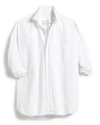 The Shirley Oversized Button-Up Shirt in White Distressed Famous Denim by Frank & Eileen features a long-sleeve collared design, rolled-up sleeves, an oversized fit, and a single chest pocket.