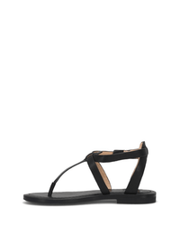 The FRYE Taylor Sandal in Black, shown from the side on a white background, features a minimalist design with full grain leather, a toe post, and an adjustable ankle strap.