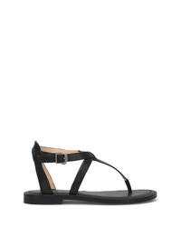 The FRYE Taylor Sandal in Black features full grain leather, a thin T-strap design, an adjustable buckle ankle strap, and an open toe, shown on a white background.