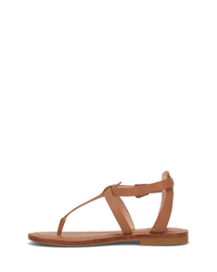 The Taylor Sandal in Tan by FRYE features a full grain leather T-strap, adjustable ankle strap with buckle, and a brown flat sole, shown in profile on a white background.